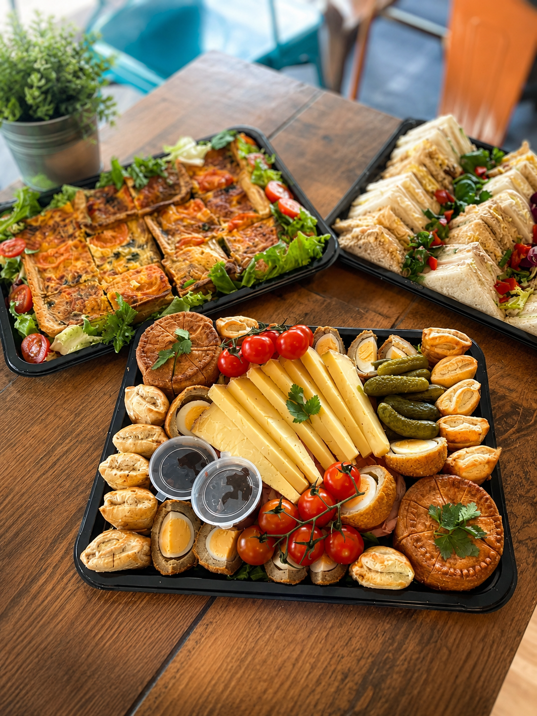A sharing platter with savoury bites, sandwiches, cheese and salad